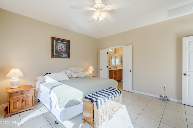 bedroom with ceiling fan, light tile patterned flooring, and ensuite bathroom