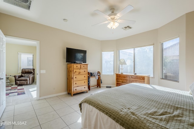 bedroom with ceiling fan and light tile patterned floors