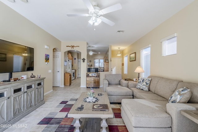 living room featuring ceiling fan and light tile patterned floors