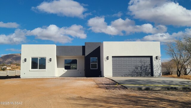 rear view of house featuring a garage