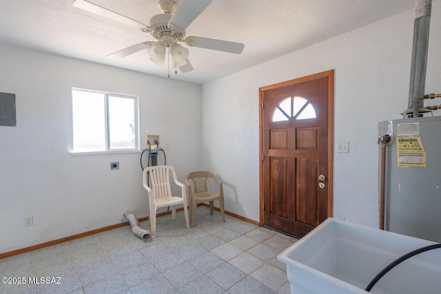 entryway featuring ceiling fan, electric panel, gas water heater, and a healthy amount of sunlight