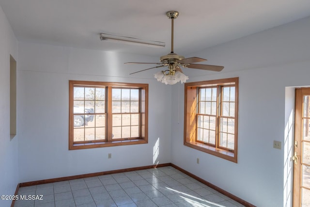 empty room featuring ceiling fan and plenty of natural light