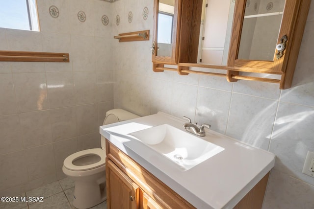 bathroom featuring toilet, tile walls, tile patterned floors, and vanity