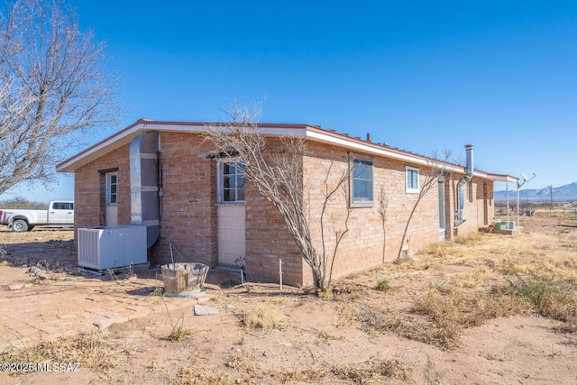 view of side of property with central AC unit