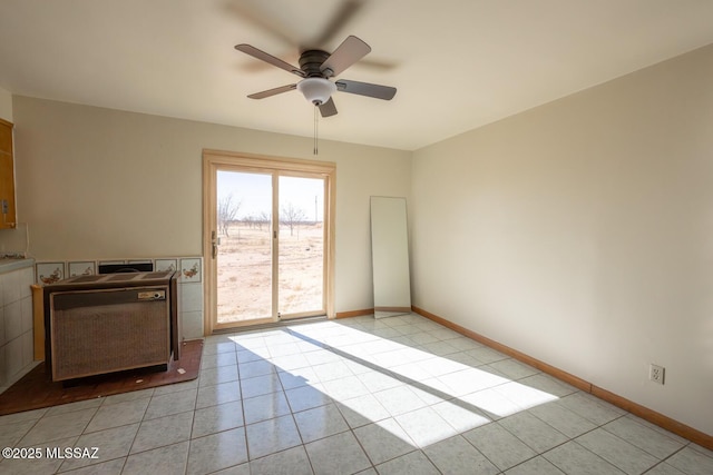 unfurnished living room featuring ceiling fan and light tile patterned floors