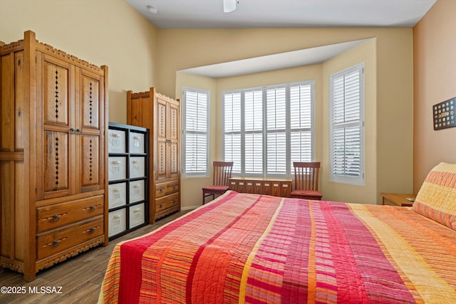 bedroom with lofted ceiling and dark hardwood / wood-style flooring