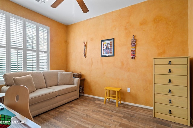 living room featuring hardwood / wood-style flooring and ceiling fan