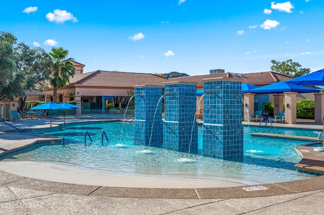 view of swimming pool featuring pool water feature