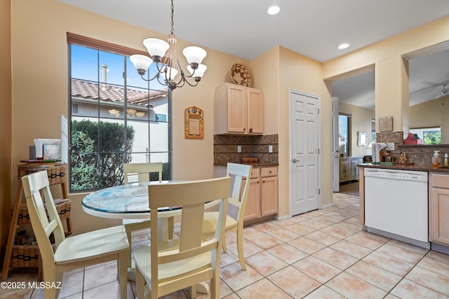 tiled dining room with a chandelier