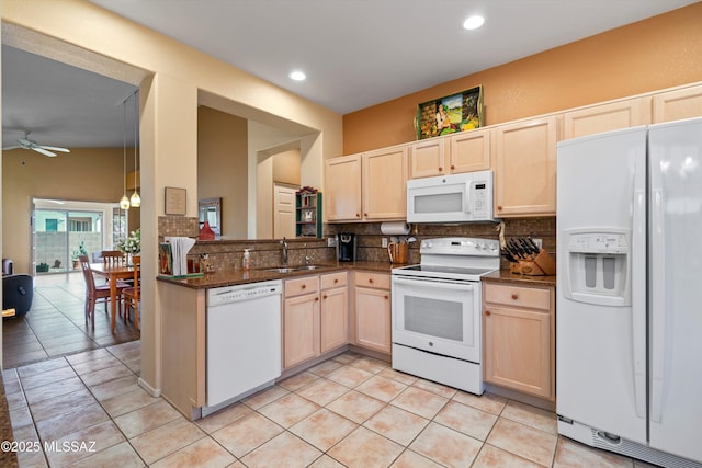 kitchen featuring white appliances, sink, decorative backsplash, and light brown cabinets