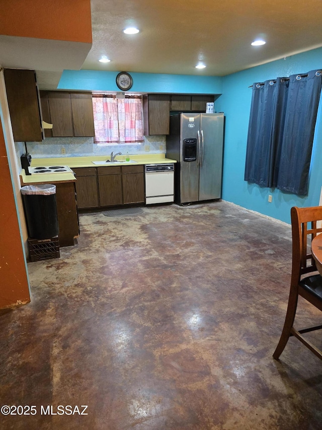 kitchen featuring white dishwasher, sink, dark brown cabinetry, and stainless steel refrigerator with ice dispenser