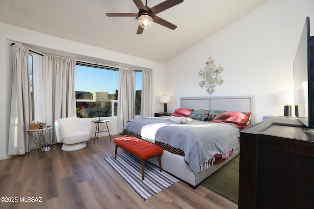 bedroom featuring ceiling fan, vaulted ceiling, and wood-type flooring