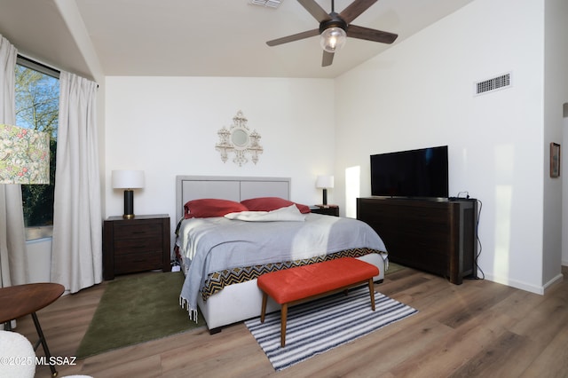 bedroom featuring ceiling fan, wood-type flooring, and lofted ceiling