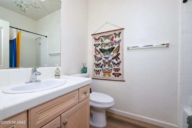 full bathroom featuring hardwood / wood-style floors, toilet, vanity, and shower / tub combo with curtain