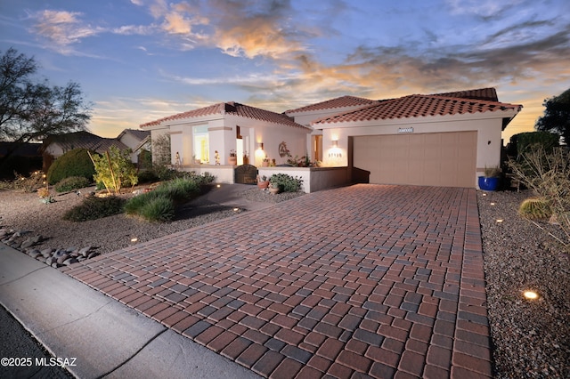 mediterranean / spanish-style home with a garage