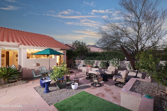 view of patio with an outdoor living space with a fire pit