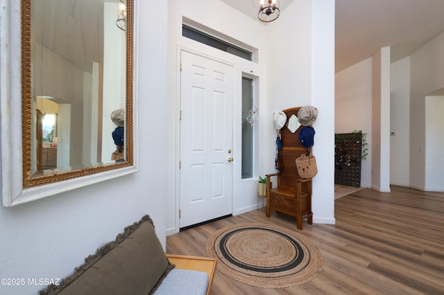 entryway featuring wood-type flooring and a notable chandelier