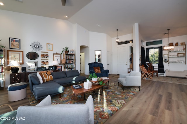 living room with wood-type flooring and vaulted ceiling