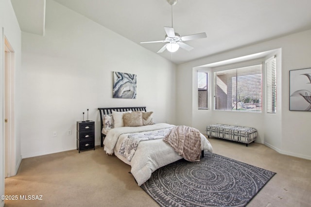 bedroom featuring ceiling fan, vaulted ceiling, and light carpet