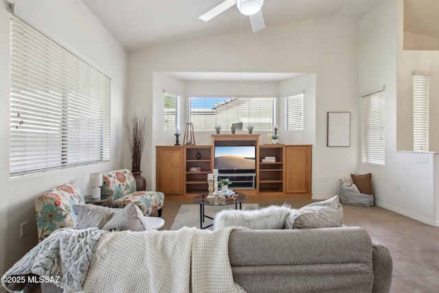 tiled living room featuring ceiling fan and vaulted ceiling