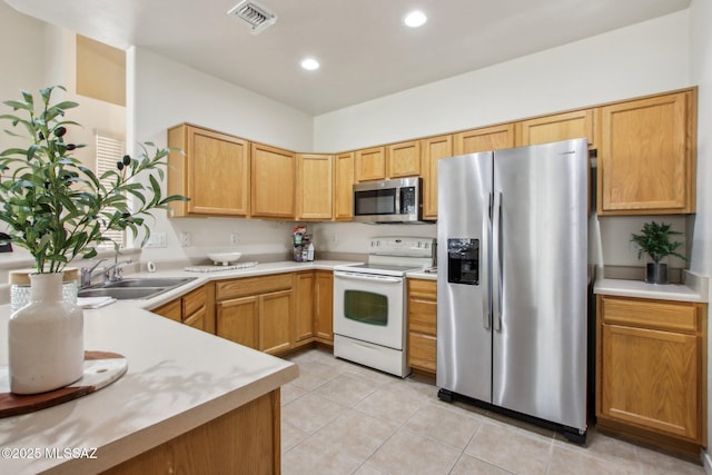 kitchen featuring sink, light tile patterned floors, and appliances with stainless steel finishes