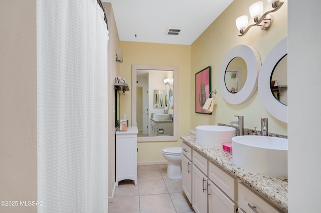 bathroom featuring tile patterned flooring, a shower with curtain, vanity, and toilet