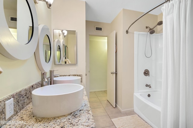 bathroom with shower / bath combo, tile patterned floors, and sink