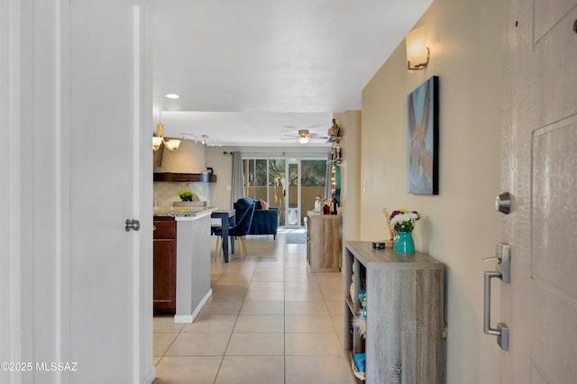 hall with light tile patterned floors