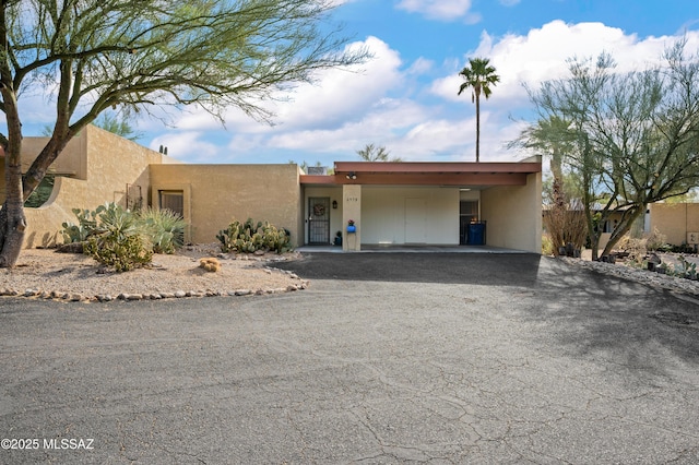 pueblo-style home featuring a carport