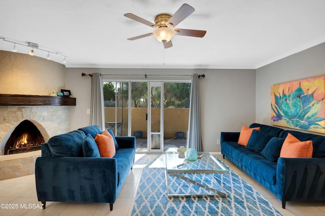 tiled living room featuring rail lighting, ceiling fan, and crown molding