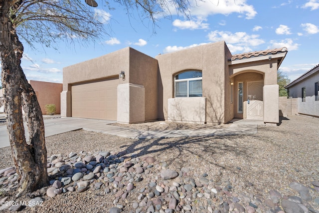 pueblo revival-style home with a garage