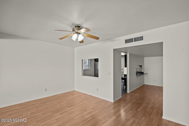 unfurnished room featuring light hardwood / wood-style flooring and ceiling fan