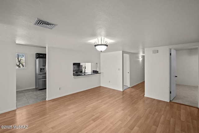 unfurnished living room with light hardwood / wood-style flooring