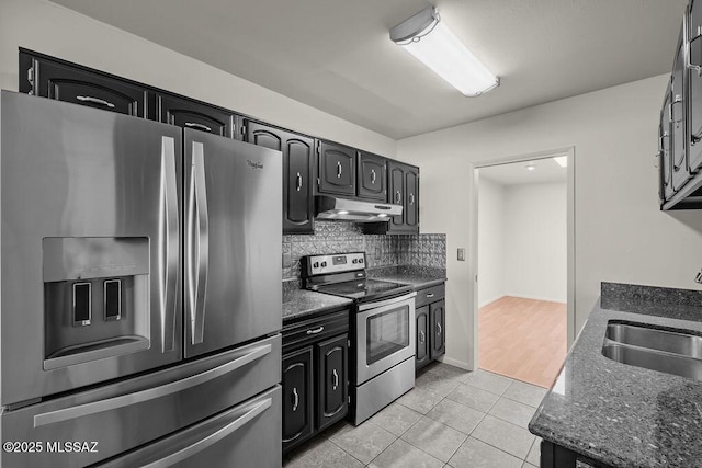 kitchen with backsplash, dark stone counters, sink, light tile patterned floors, and stainless steel appliances