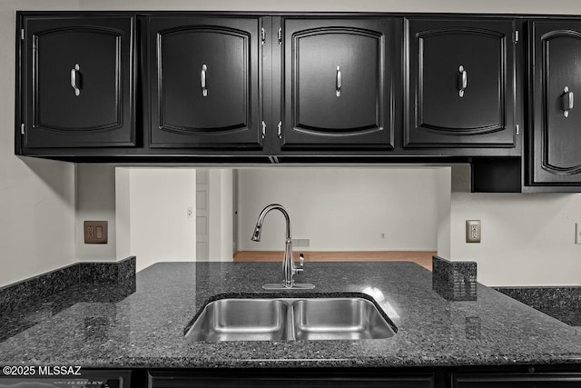 kitchen featuring sink and dark stone counters