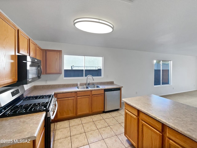 kitchen featuring light tile patterned floors, stainless steel appliances, and sink