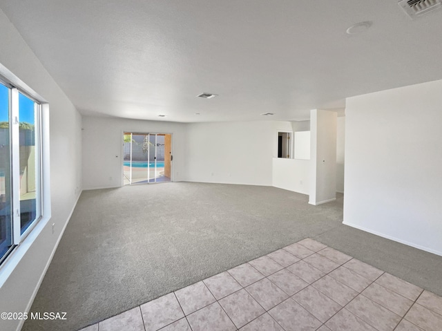 unfurnished living room with light carpet