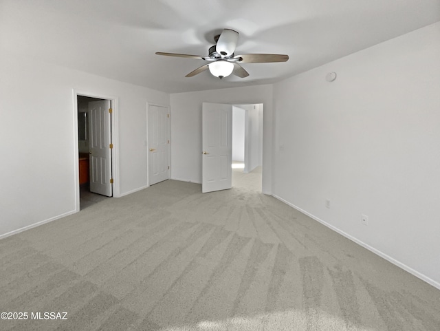 unfurnished bedroom featuring ceiling fan and light carpet