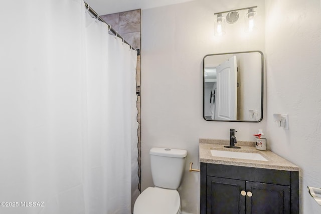 bathroom with walk in shower, vanity, and toilet