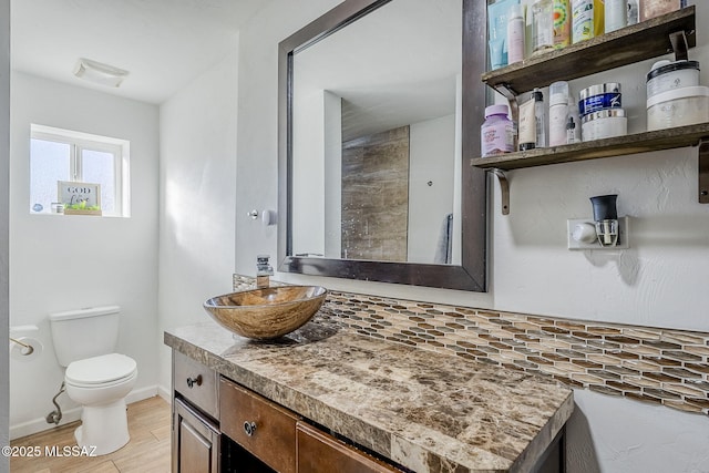 bathroom with toilet, wood-type flooring, and vanity