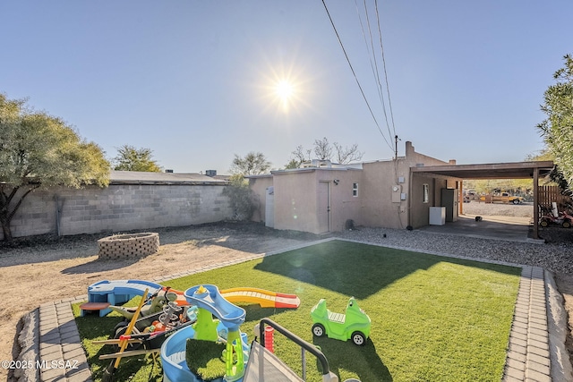 view of yard with a fire pit