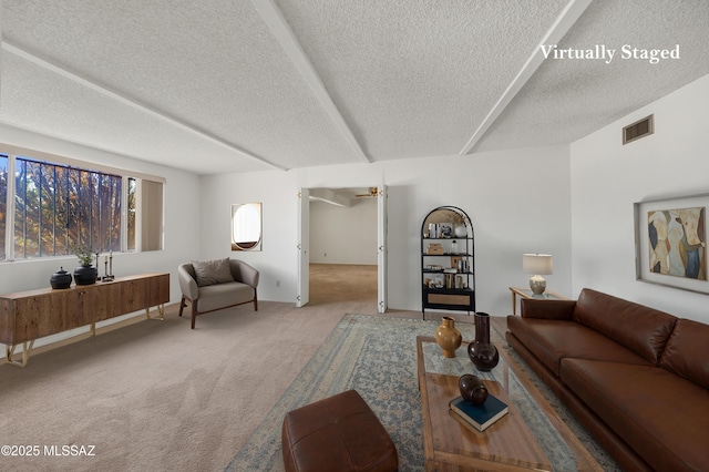 9256 E 26th St, Tucson, AZ 85710 - living room featuring carpet floors and a textured ceiling