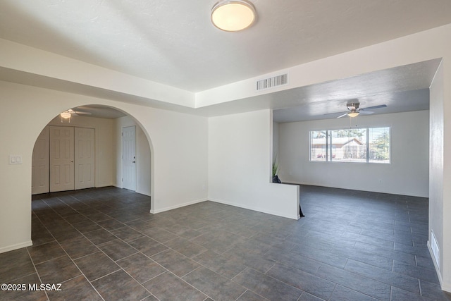 unfurnished room featuring ceiling fan