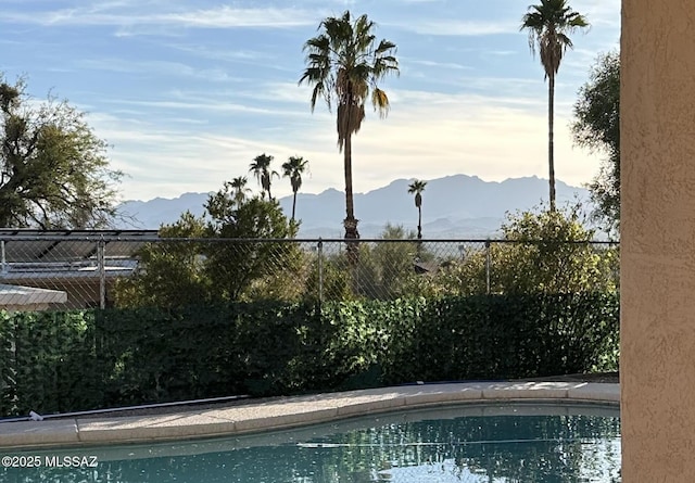 view of swimming pool with a mountain view