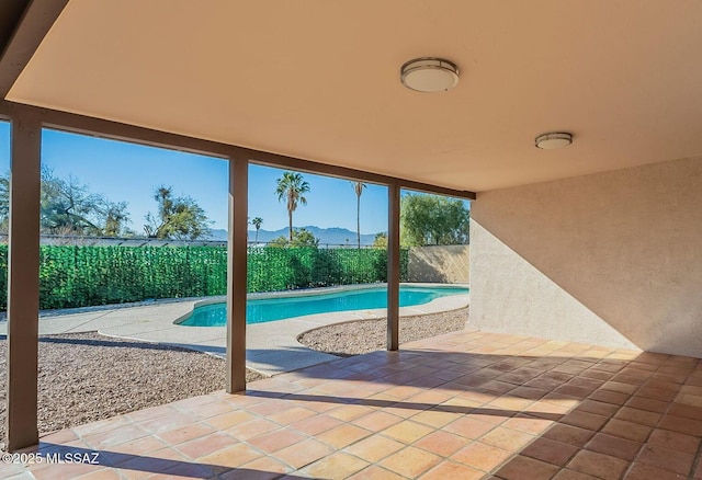 view of swimming pool with a mountain view and a patio area