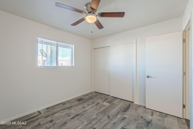 unfurnished bedroom with hardwood / wood-style floors, ceiling fan, and a closet