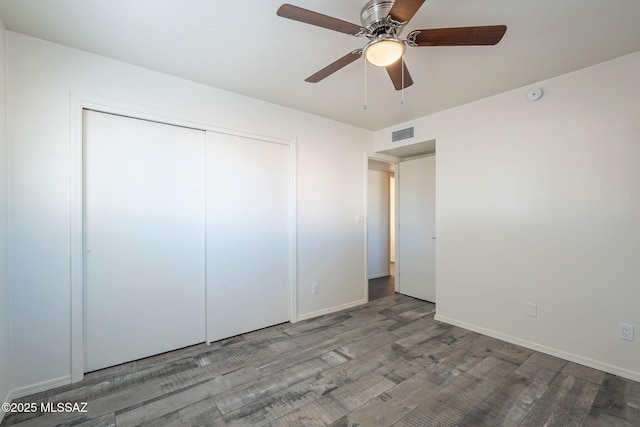 unfurnished bedroom featuring wood-type flooring, ceiling fan, and a closet