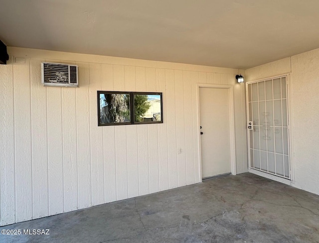 view of exterior entry featuring a patio area