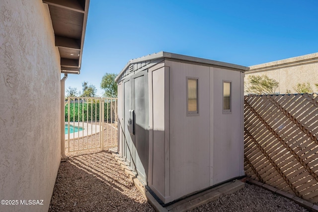 view of outbuilding with a fenced in pool