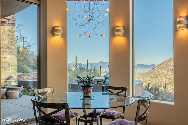 dining space featuring a chandelier and a mountain view